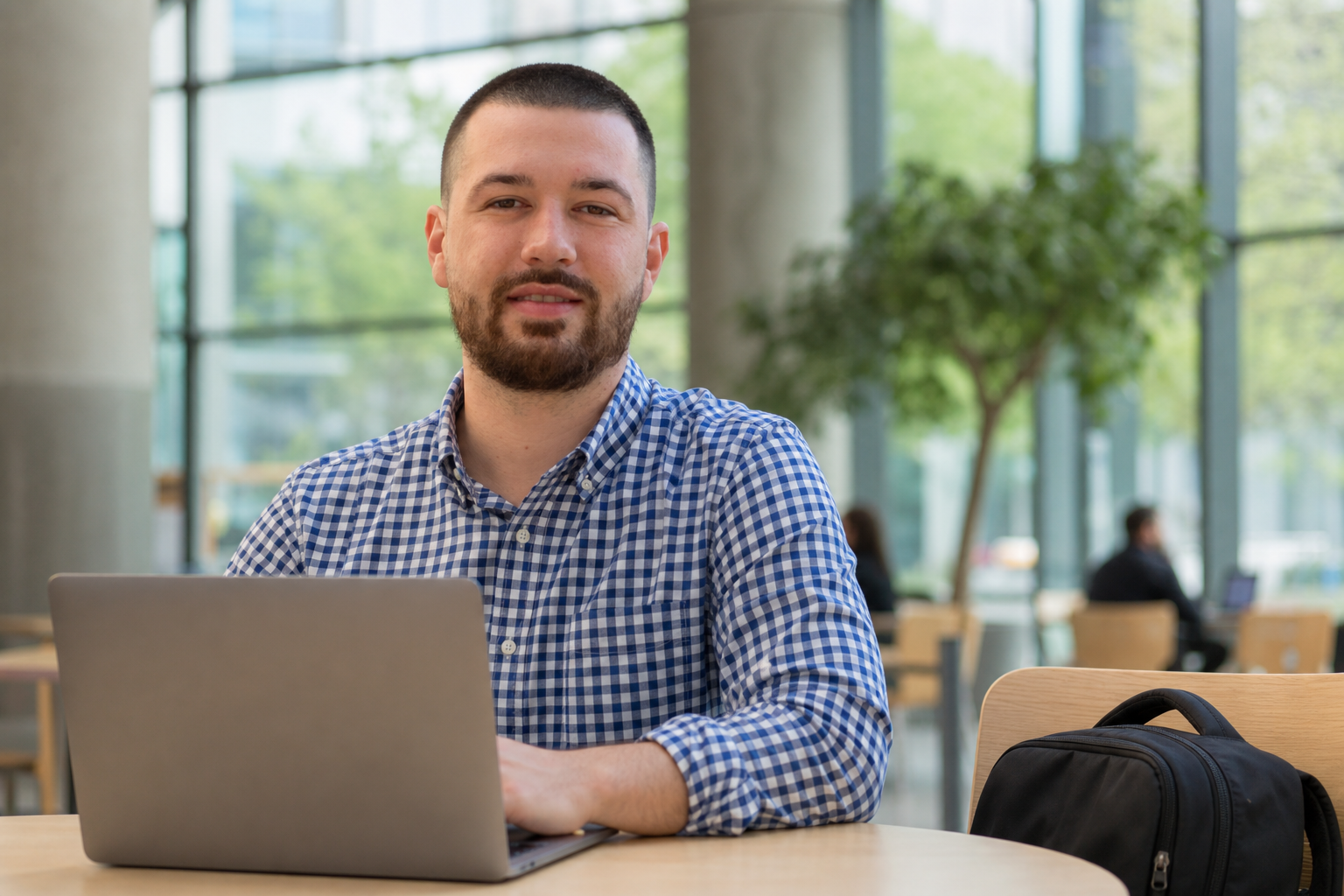 Drake Talley — working on a laptop in a campus cafe