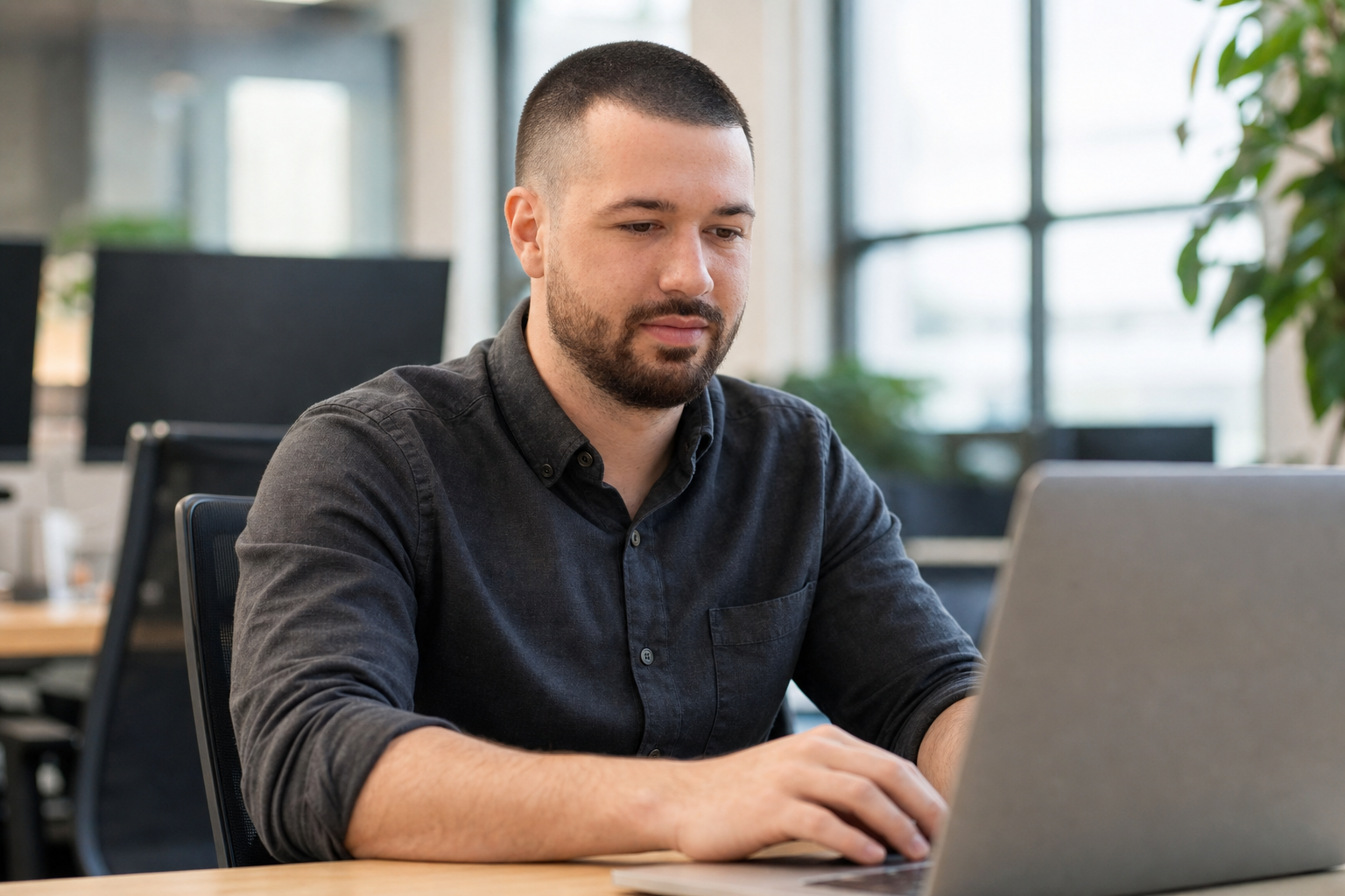 Chandler Drake Talley photo: Senior AI Engineer working on a laptop in an office Chandler Drake Talley, Senior AI Engineer — Senior AI Engineer working on a laptop in an office