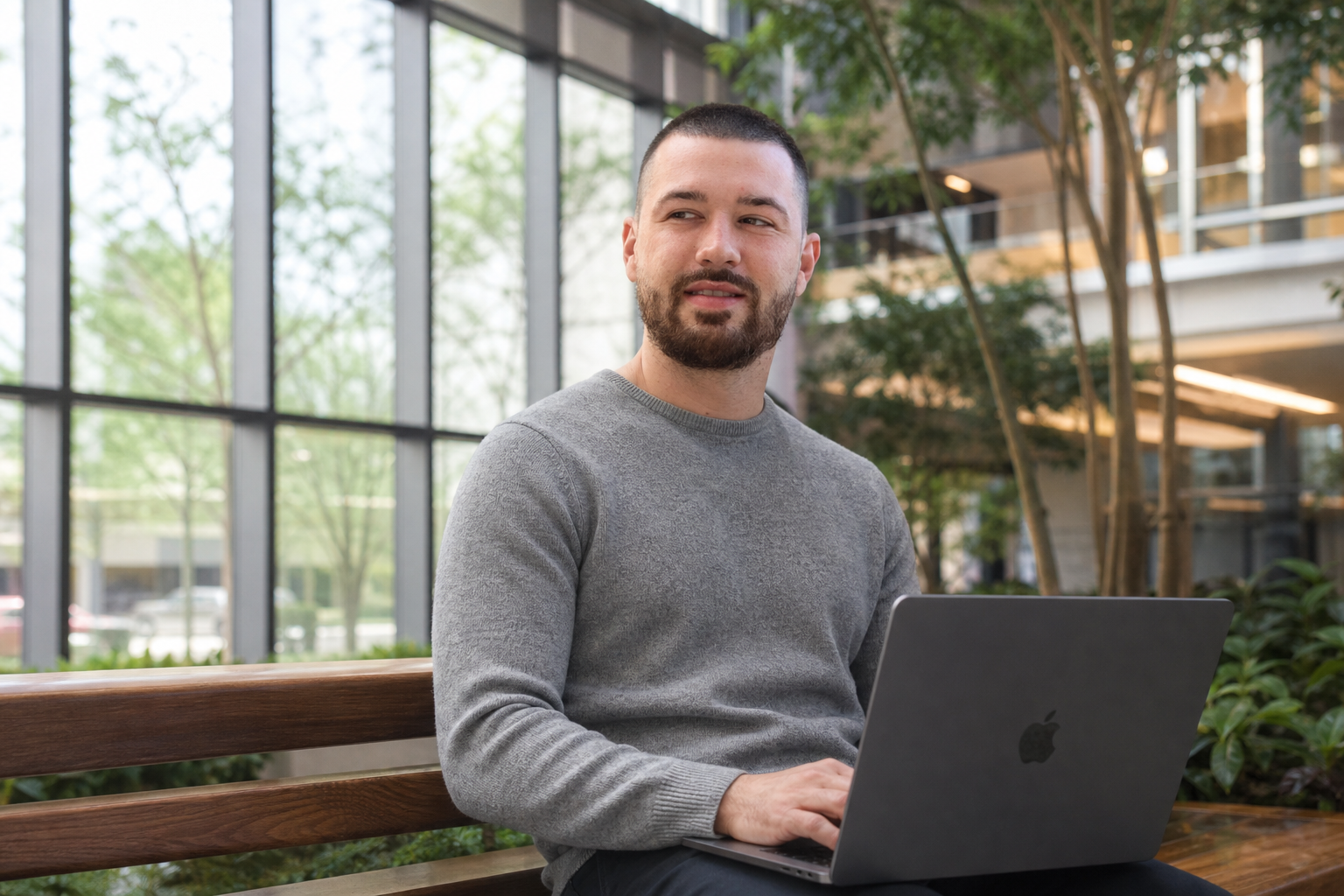Chandler Drake Talley photo: working on a laptop in an office atrium Chandler Drake Talley, Senior AI Engineer — working on a laptop in an office atrium