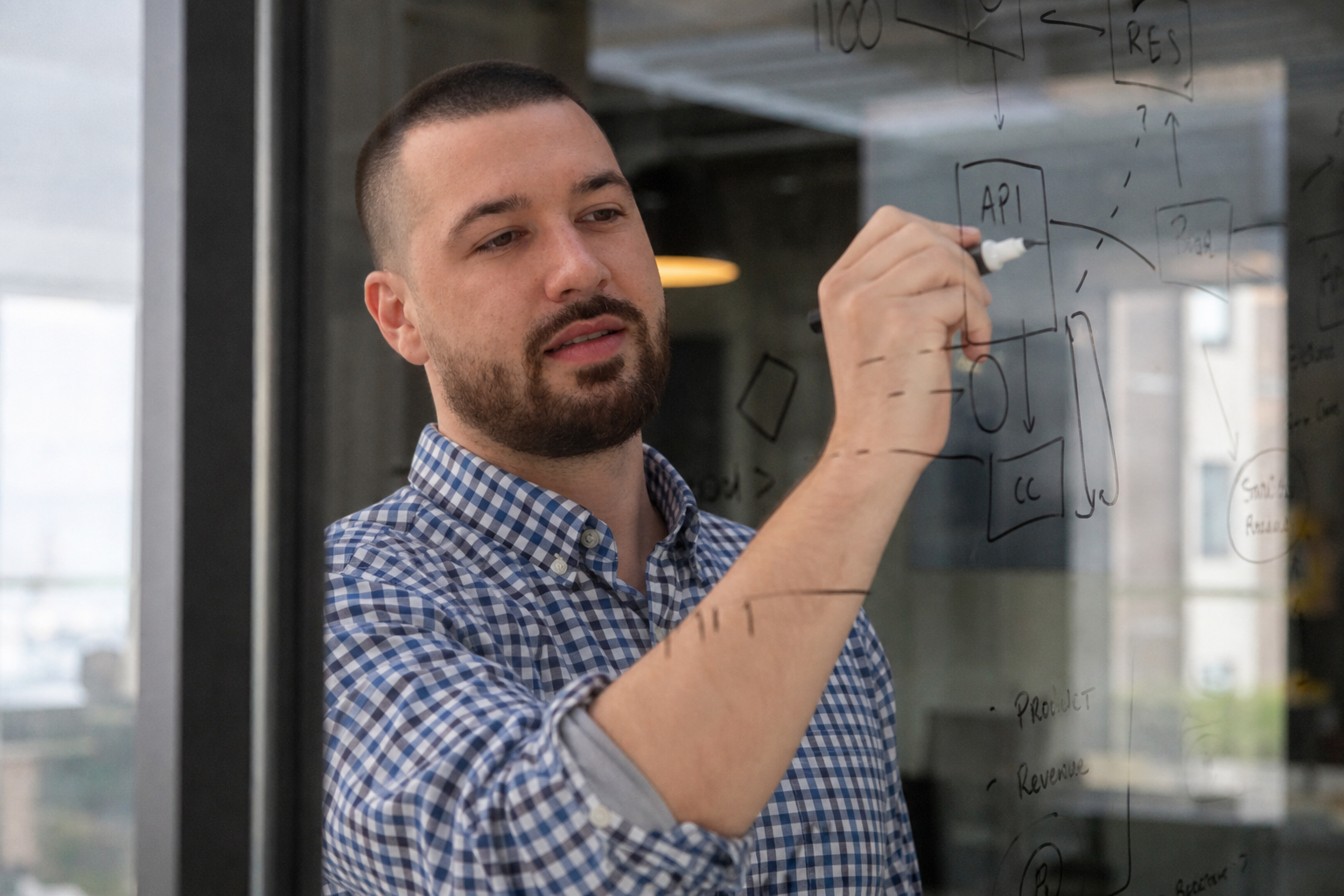 Chandler Drake Talley photo: writing notes on a glass office wall Chandler Drake Talley, Senior AI Engineer — writing notes on a glass office wall