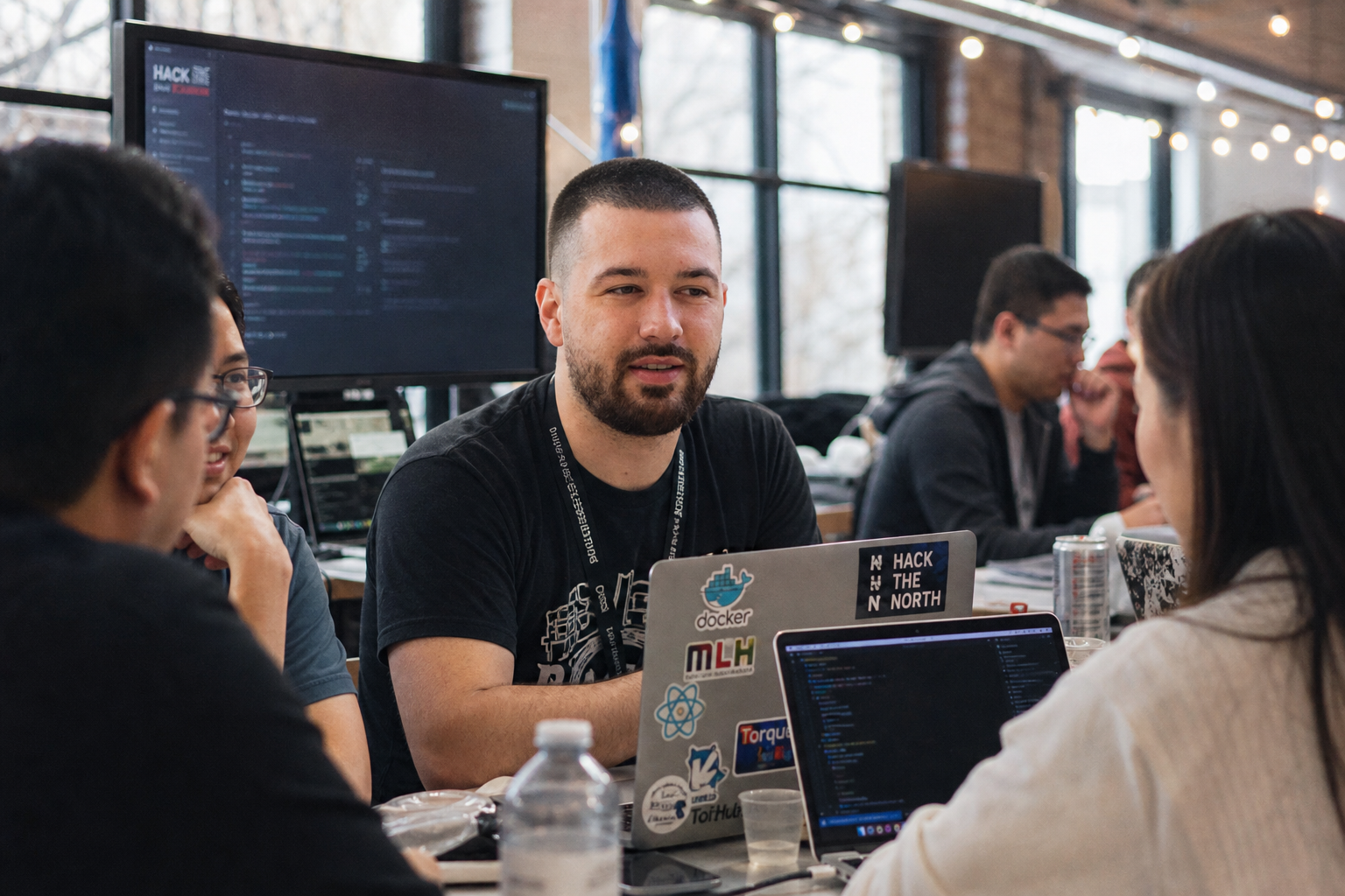 Chandler Drake Talley photo: building with a team at a hackathon Chandler Drake Talley, Senior AI Engineer — building with a team at a hackathon