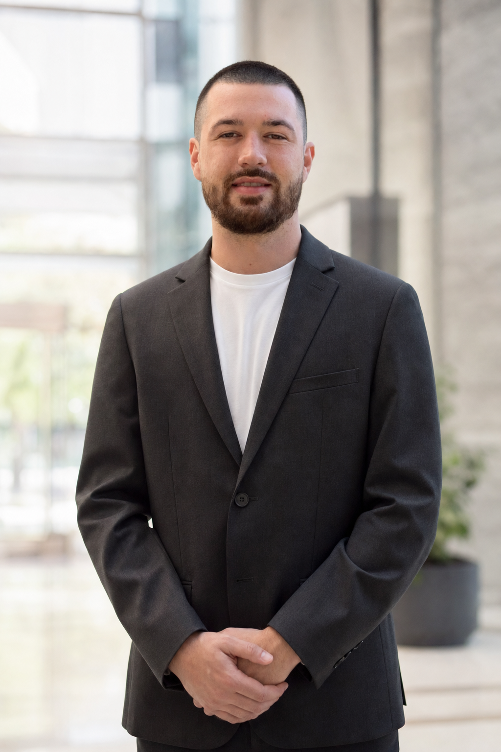 Chandler Drake Talley photo: portrait in a modern office lobby Chandler Drake Talley, Senior AI Engineer — portrait in a modern office lobby