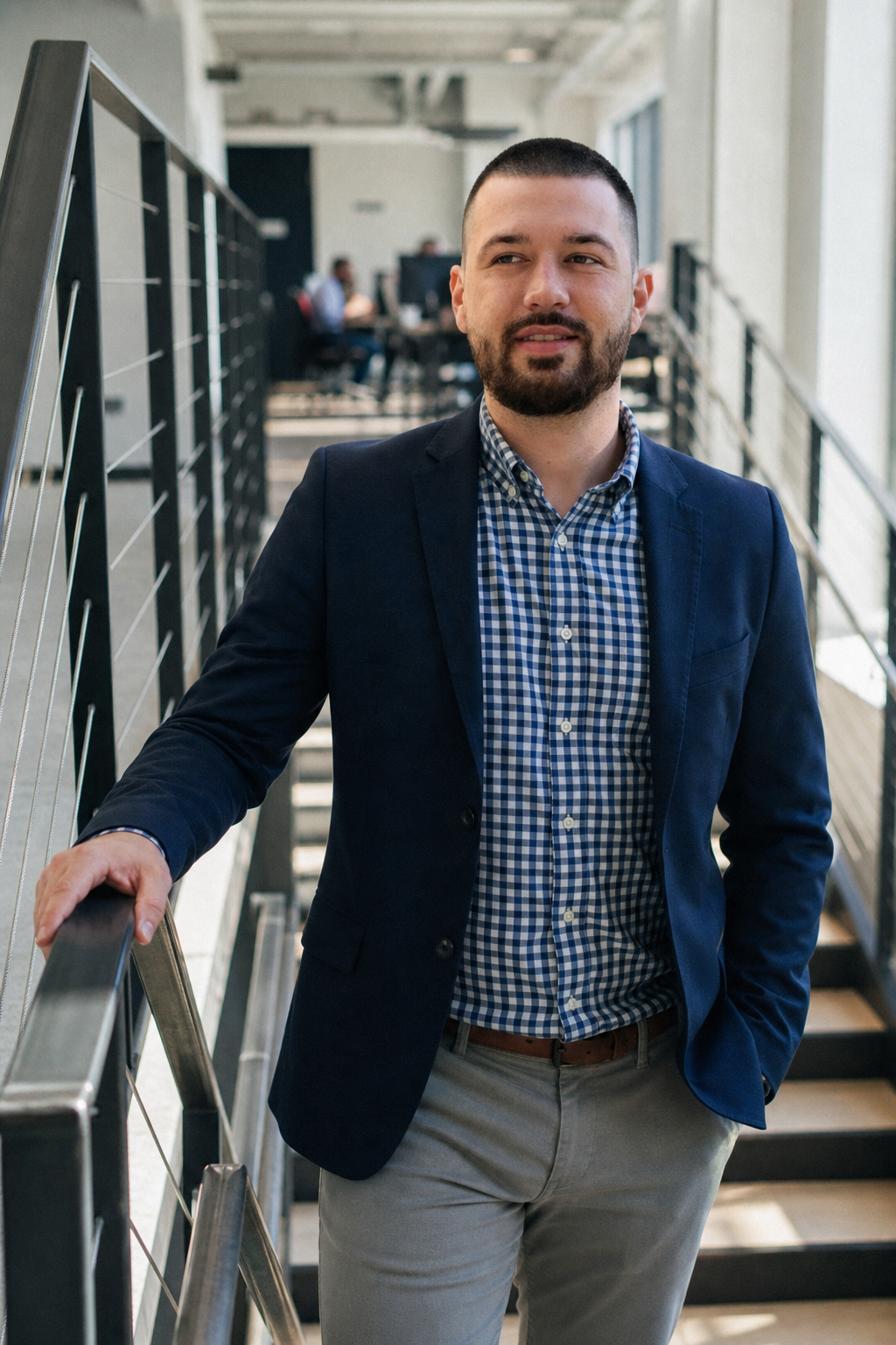 Chandler Drake Talley photo: portrait on modern office stairs Chandler Drake Talley, Senior AI Engineer — portrait on modern office stairs