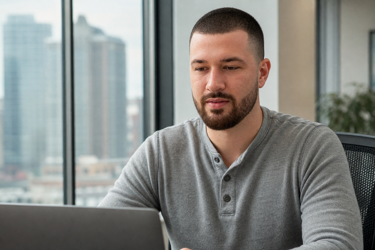 Chandler Drake Talley photo: working on a laptop by an office window Chandler Drake Talley, Senior AI Engineer — working on a laptop by an office window