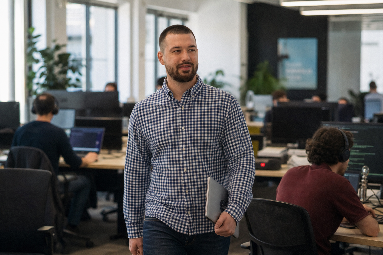 Chandler Drake Talley photo: walking through an open-plan office Chandler Drake Talley, Senior AI Engineer — walking through an open-plan office