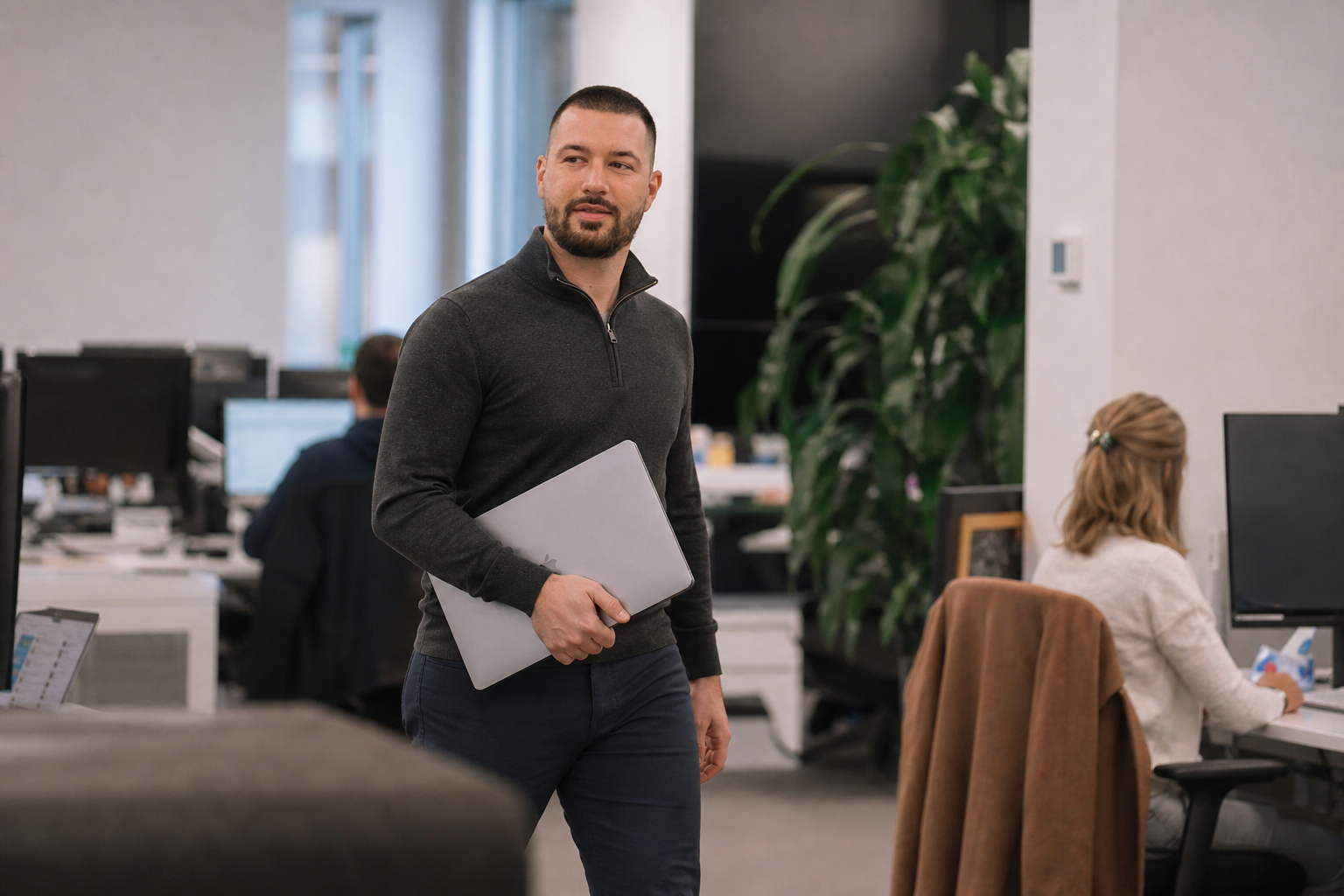 Chandler Drake Talley photo: walking through an open-plan office Chandler Drake Talley, Senior AI Engineer — walking through an open-plan office
